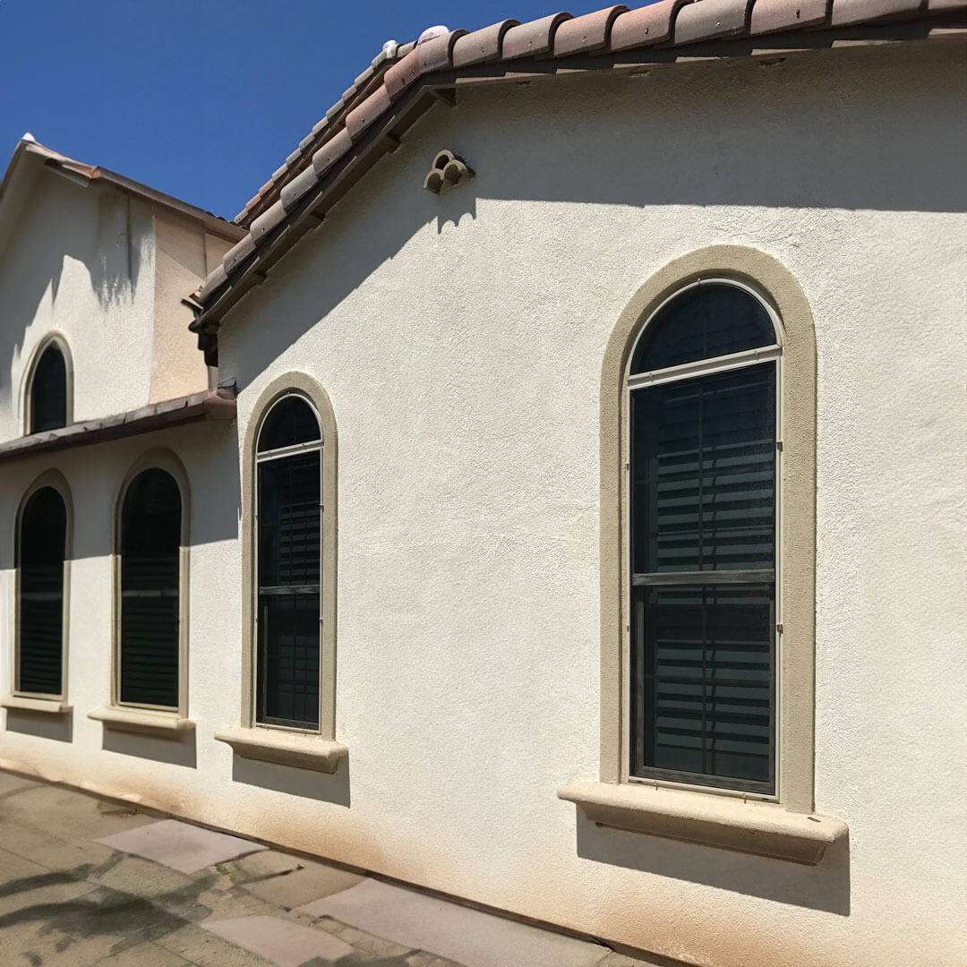 Specialist measuring custom-sized window screens on a home in SDCE