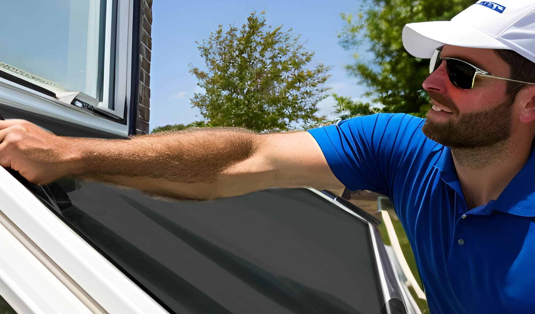 Technician repairing a window screen on site